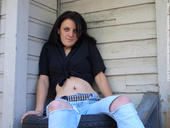 Lexi - Me sitting on tires on the side of a house